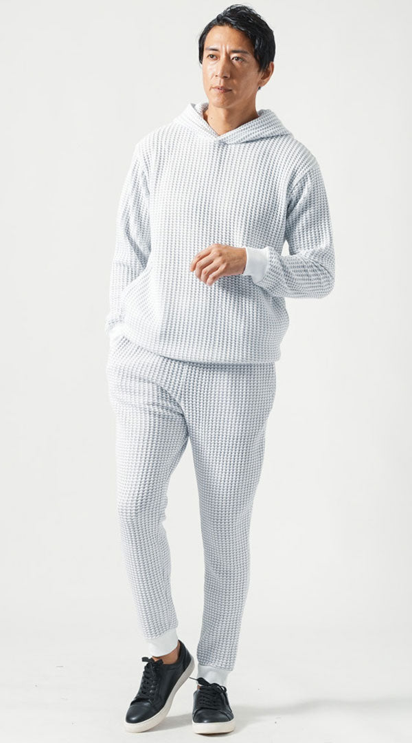 メンズのジョガーパンツセットアップに黒スニーカーを合わせた引き締まったモノトーンコーディネート